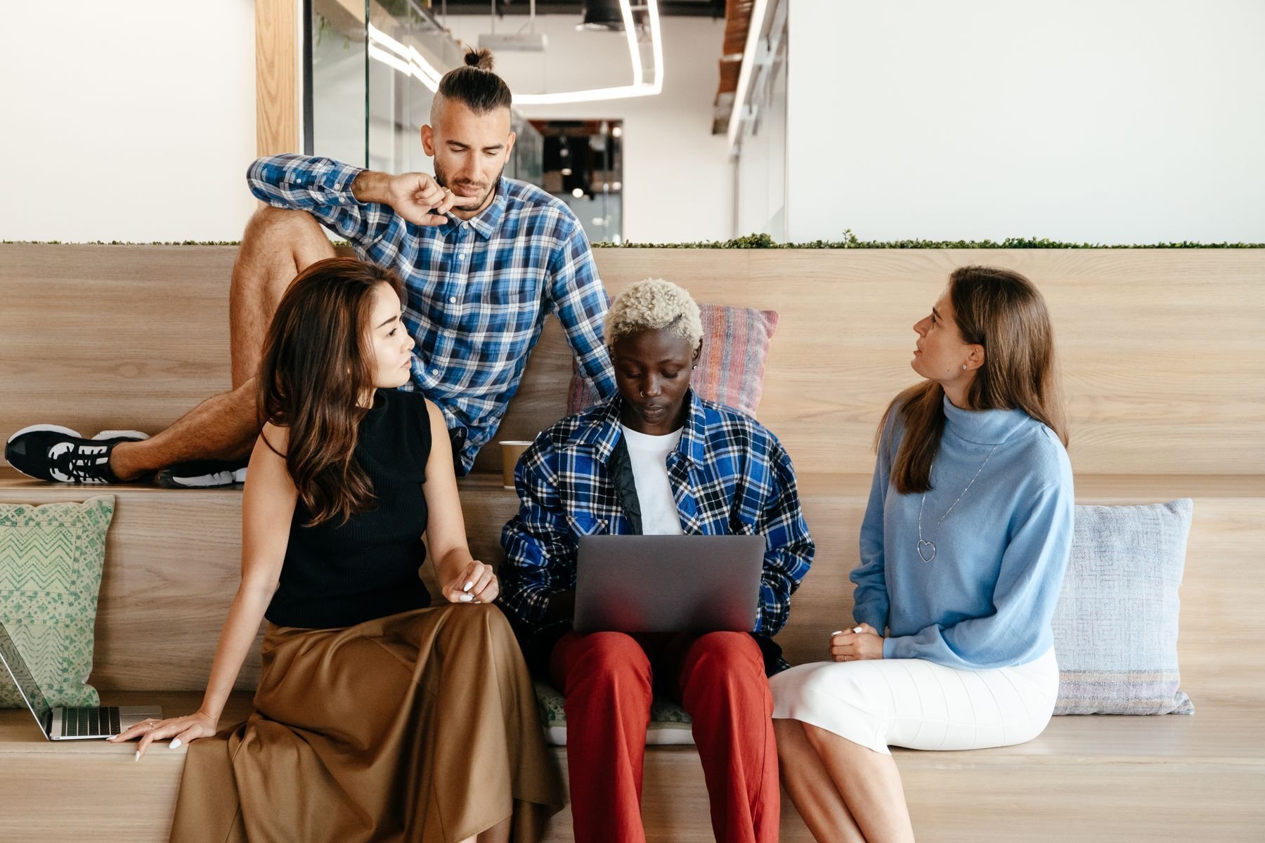 Colleagues reviewing work together in a bright office